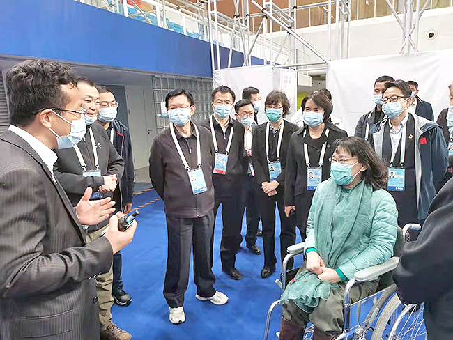 图为张海迪听取国家游泳中心无障碍设施介绍