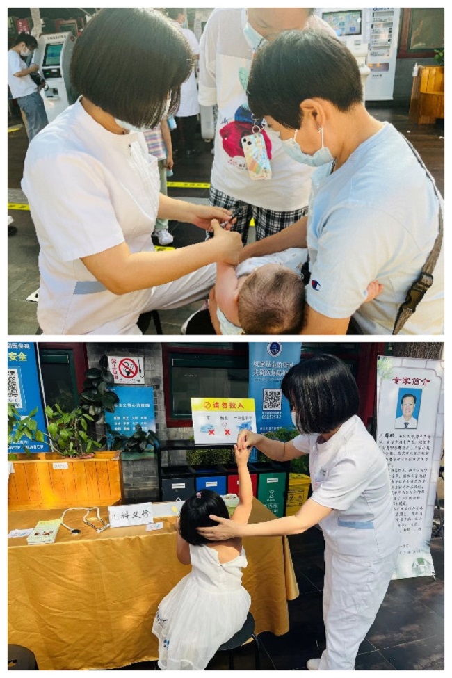 图为医务人员为义诊儿童检诊