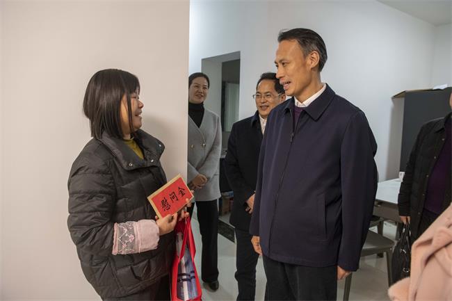 图为尹华凯看望慰问团洲乡受灾残疾人阳红
